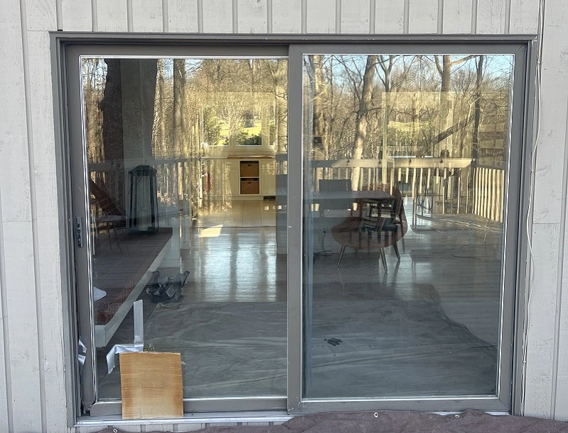A sliding patio door in New Canaan with a disintegrating frame